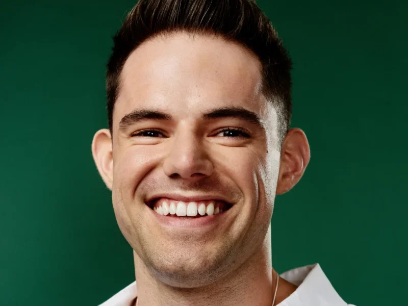 Headshot of Gay Times CEO Tag Warner smiling at camera
