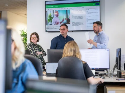 Business Post: From ‘shocking’ engagement to 12,000 subscribers Business Post managing editor Gilian Nelis (left), deputy editor Aaron Rogan (centre) and editor Daniel McConnell (right) in the newsroom standing in front of a TV screen showing the Business Post website