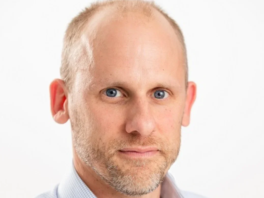 Reach chief executive Piers North - headshot on white backdrop