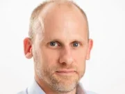 Reach chief executive Piers North - headshot on white backdrop