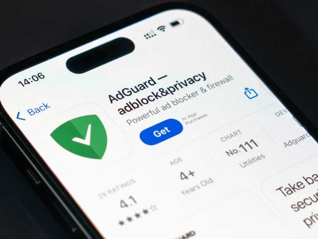 AdGuard app in app store displayed on smartphone screen with logo.