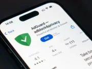 AdGuard app in app store displayed on smartphone screen with logo.