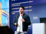Beehiiv CEO and co-founder Tyler Denk giving a presentation with text on a slide behind him. Discusses newsletter market in 2026