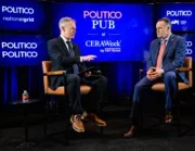 Politico deputy editor-in-chief Joe Schatz interviews American Petroleum Institute president Mike Sommers, both sitting on stools on stage, at the Politico Pub in CeraWeek with logos and branding behind them