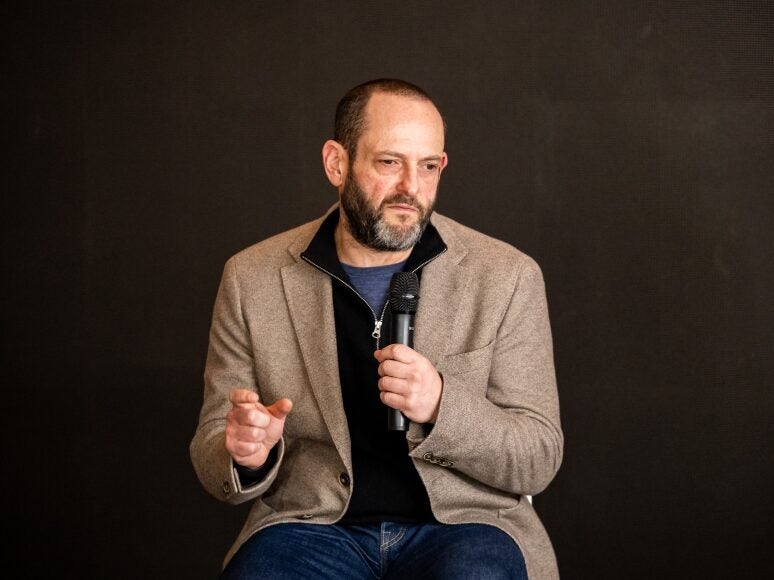 Sky News executive editor Jonathan Levy speaking into a microphone and gesturing