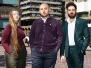 New Sunday Times Insight investigations team from left to right: Venetia Menzies, Gabriel Pogrund, and Emanuele Midolo standing side by side in large courtyard with buildings behind
