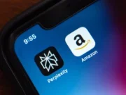 Amazon and Perplexity app logos on a phone with plain background