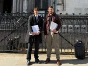 Freelance journalist Cormac Kehoe and Mill Media founder Joshi Herrmann stand next to each other smiling outside the Royal Courts of Justice in London