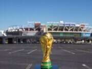 World Cup trophy pictured in front of a stadium