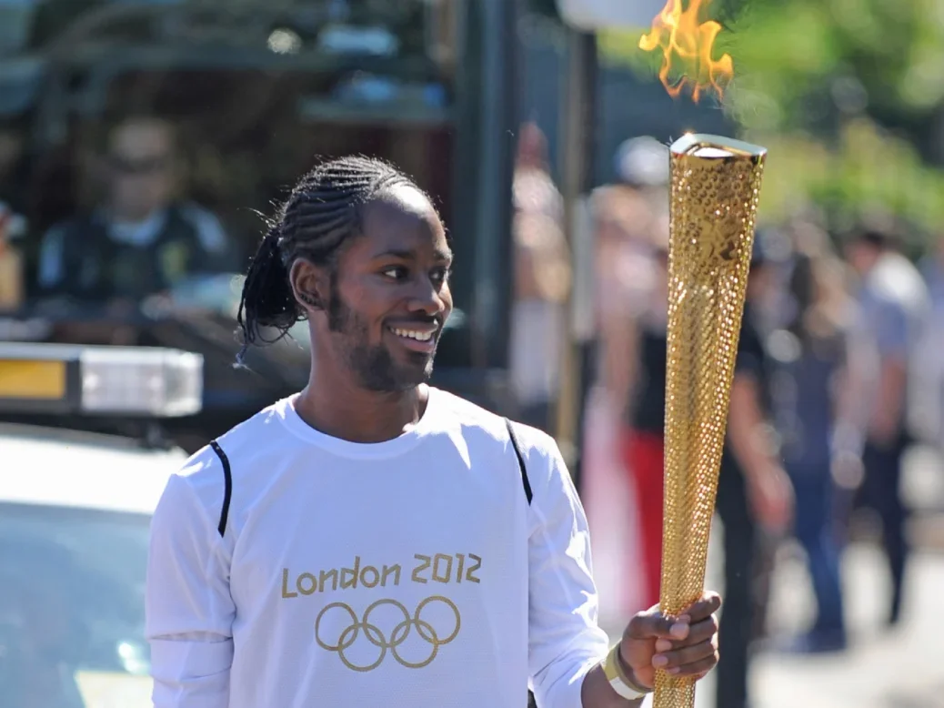 Jason Arday carries the Olympic torch