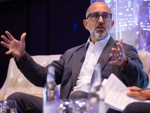 Financial Times chief executive Jon Slade at Press Gazette's Future of Media Technology Conference on stage gesturing with both arms while answering a question