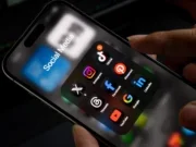 Social media app folder on a phone, featuring icons for X, Instagram, Tiktok, Threads, Facebook, Pinterest, Youtube, Google and Linkedin