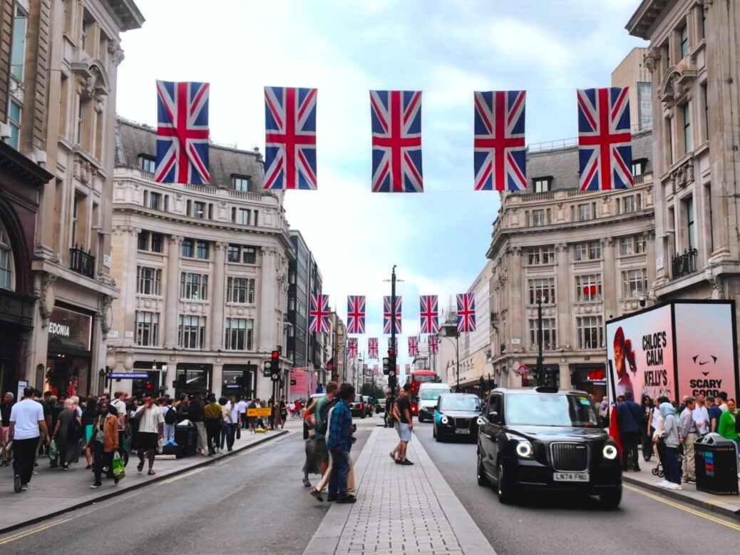 Oxford Street featuring pedestrains and taxis.