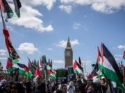 A Palestine solidarity demonstration marches past the UK Parliament in Westminster.