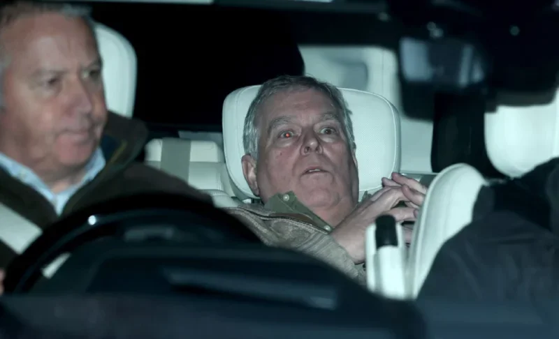 Prince Andrew being driven away from Aylsham Police station after a day of questioning, slumped in backseat of a car