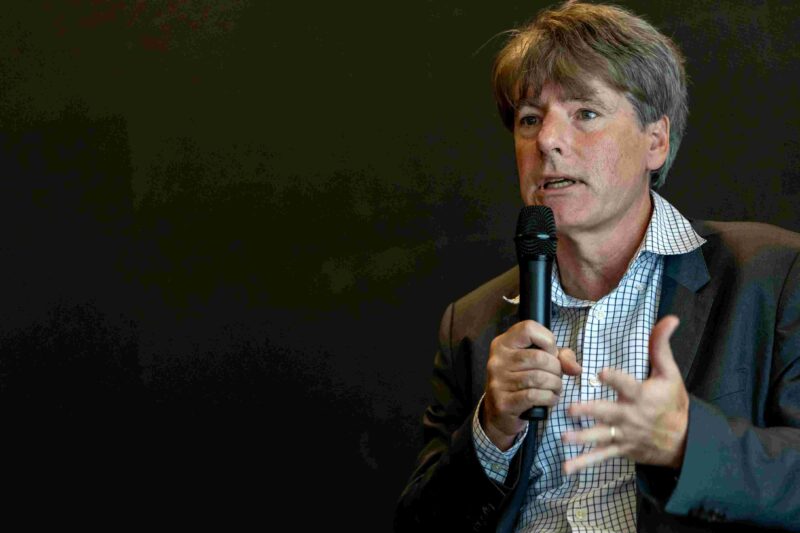 Metropolis CEO Robert Marr speaking into microphone with dark backdrop